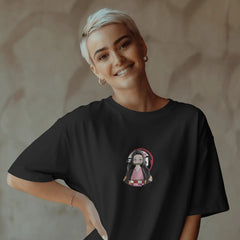 Person wearing a black t-shirt with a graphic design on a textured wall background