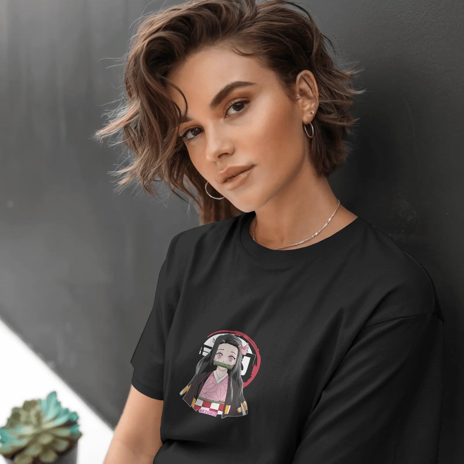 Person wearing a black t-shirt with a graphic design against a dark background