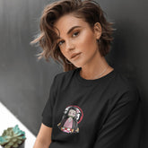 Person wearing a black t-shirt with a graphic design against a dark background